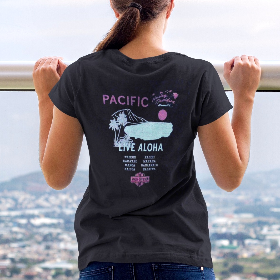 Harley-Davidson Women's Live Aloha Tour Black T-shirt. Inspired by an old Waikiki Shell concert poster. This design lists some of our favorite places on Oahu.